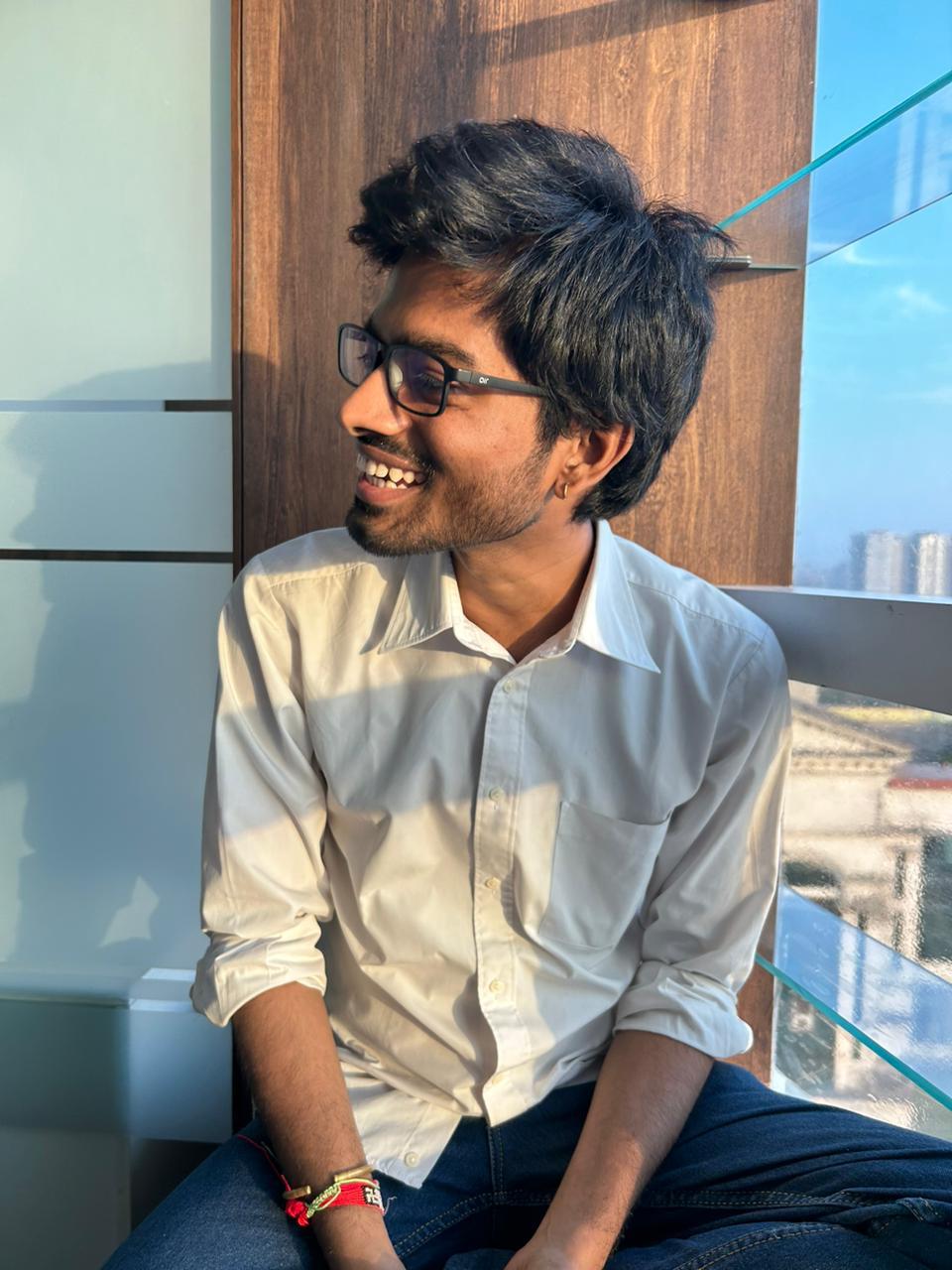 Laughing candid by the window in a white shirt