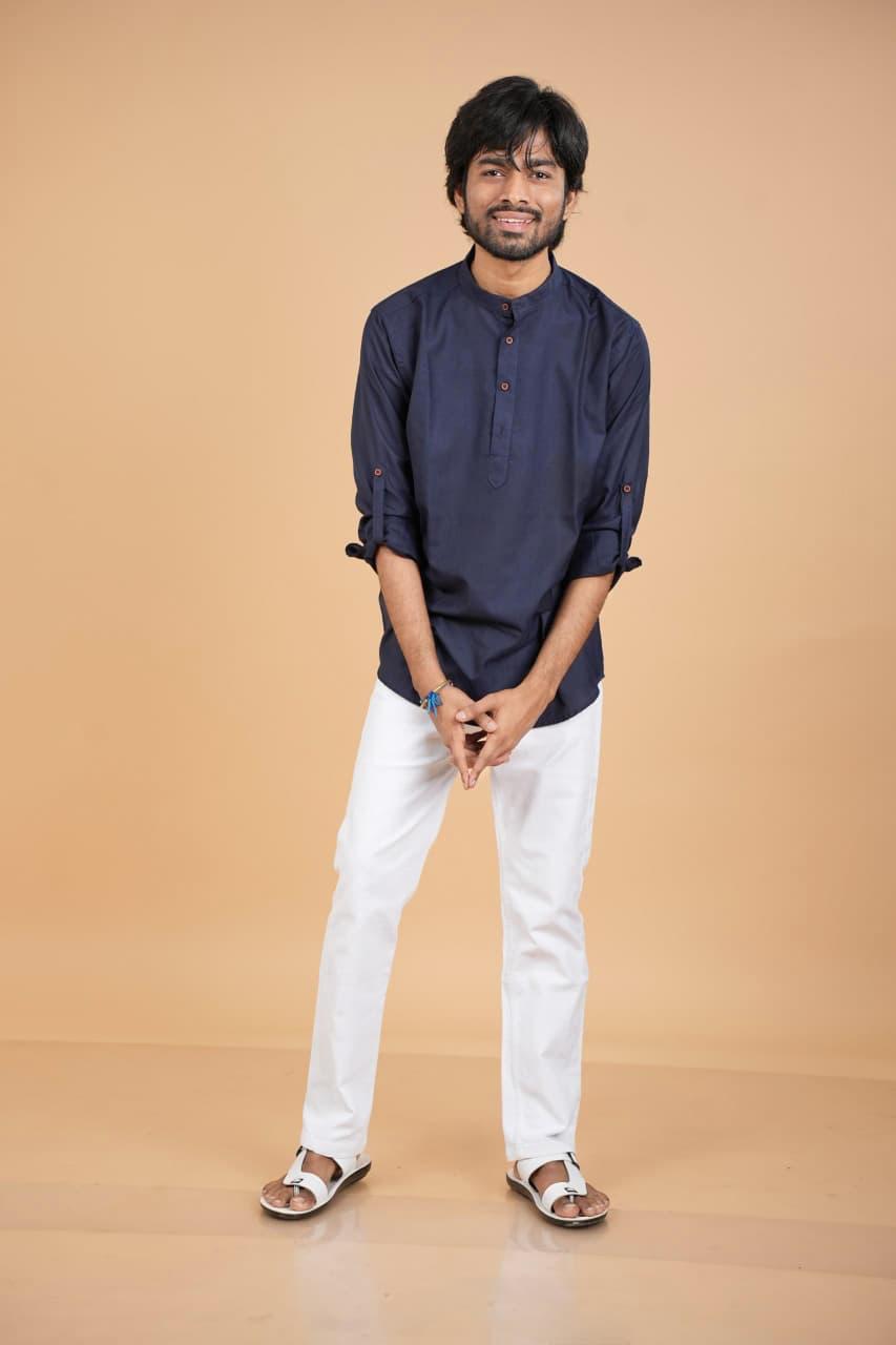 Full length standing look in navy kurta and white trousers