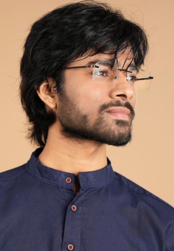 Shiv Saurabh Shukla, navy kurta with rimless glasses