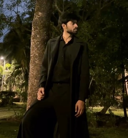 Cinematic night look in a long black coat