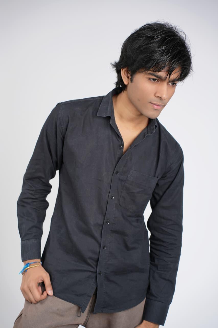 Studio portrait looking away, dark shirt